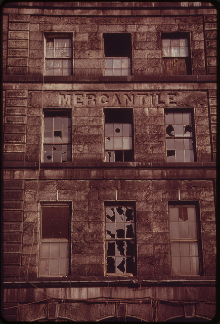 brick front of Boston mercantile building with broken windows